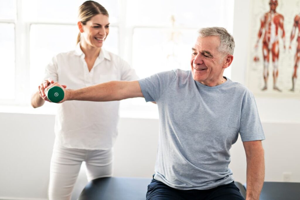 Modern rehabilitation physiotherapy worker with senior patient.